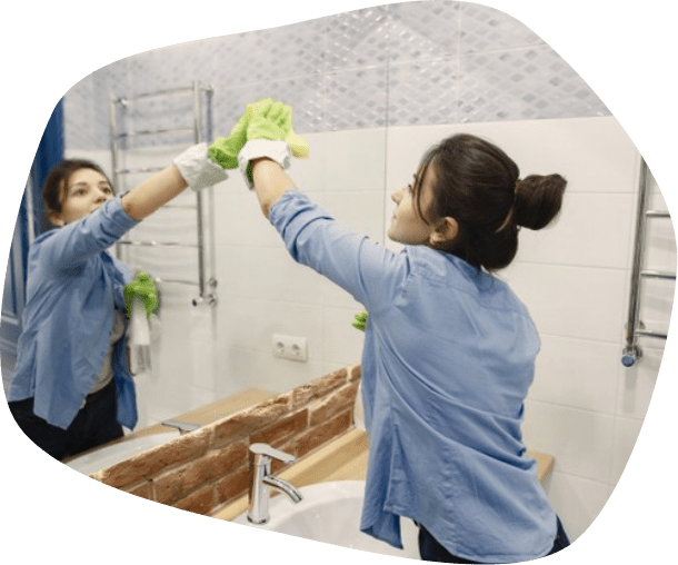 woman cleaning mirror