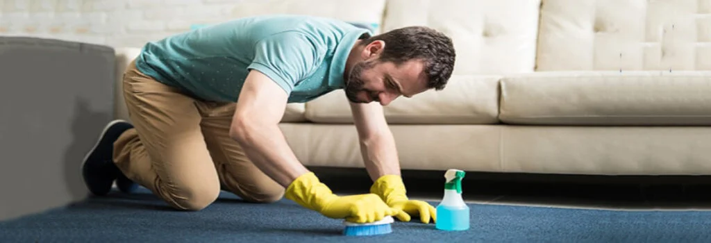 man-cleaning-carpet-by-hand