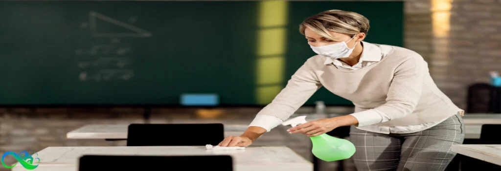 woman-cleaning-school-tables-by-hand-with-mask